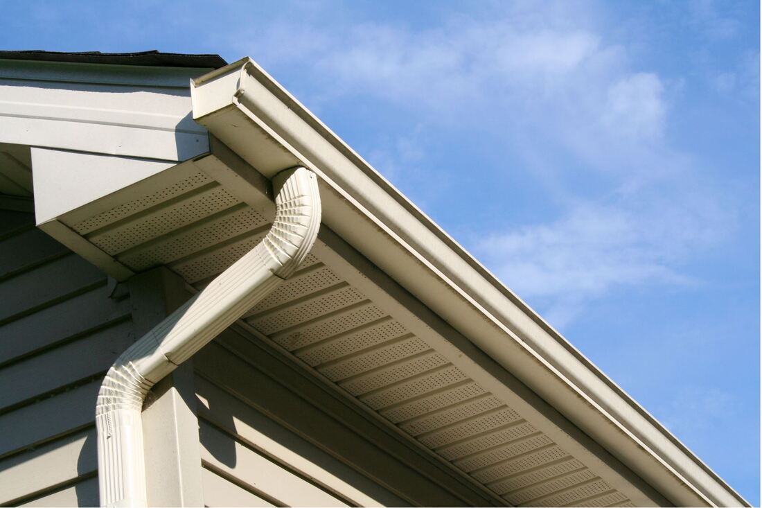 Low angle photo of a house with guttering and downspout